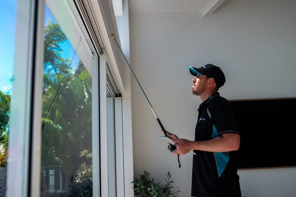 Inspector demonstrating what a building and pest inspection service includes